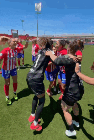 a group of female soccer players celebrate on the field with one wearing number 20