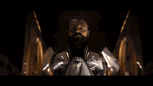 a man is standing in front of a machine in a room with a light coming through the door .
