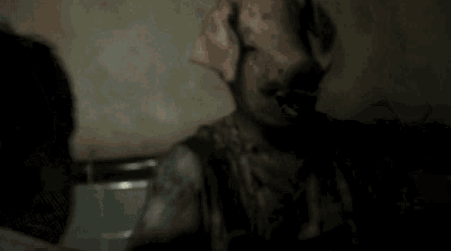 a man in a plaid shirt is bleeding from his chest