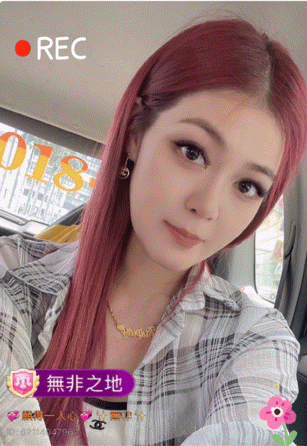 a girl with red hair is sitting in a car with a rec button