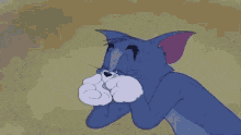 a cartoon cat named tom is holding a magnifying glass in his mouth .