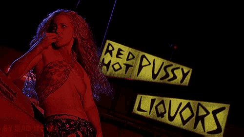 a woman stands in front of a sign that says " red pussy hot pussy liquors "