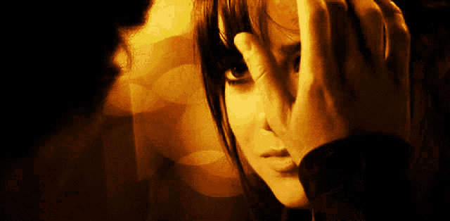 a woman is covering her face with her hand