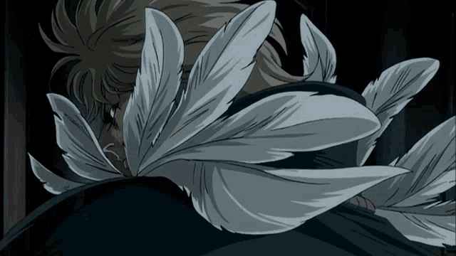a close up of a person 's face with feathers covering it