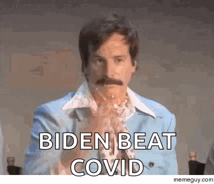 a man with a mustache is sitting at a table with his hands folded and says biden beat covid