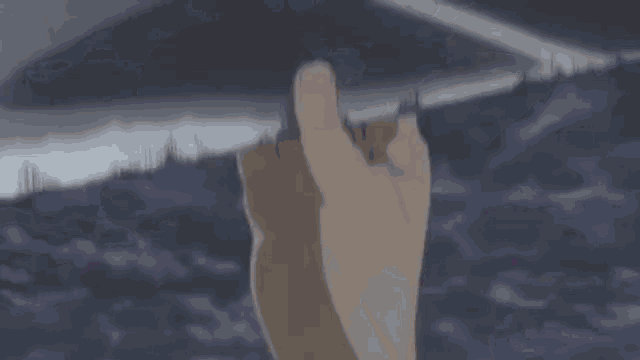 a close up of a person 's hand holding a knife .