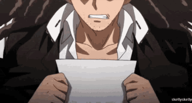 a close up of a man holding a piece of paper with skellyskelly written below it