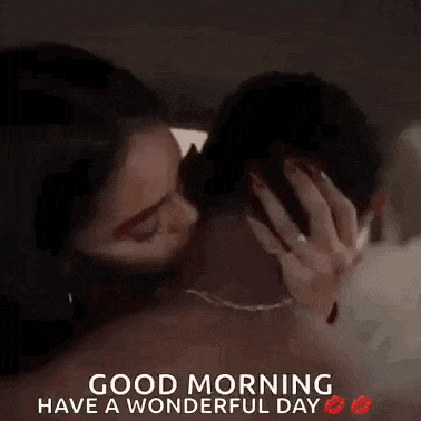 a woman is kissing a man on the neck and the words `` good morning have a wonderful day '' are on the bottom .