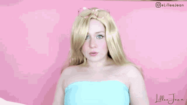 a woman in a wig and sunglasses is making a funny face .