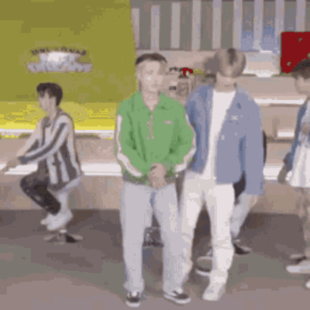 a group of people are standing in a room .