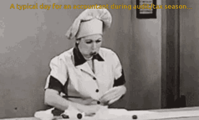 a black and white photo of a woman in a chef 's hat