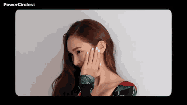 a woman covering her face with her hand with the words powercircles visible in the corner