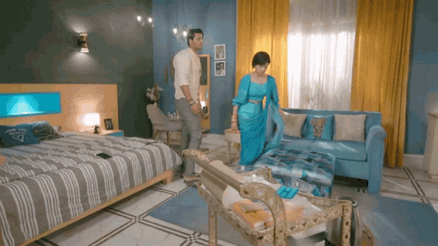 a man and woman are standing in a bedroom
