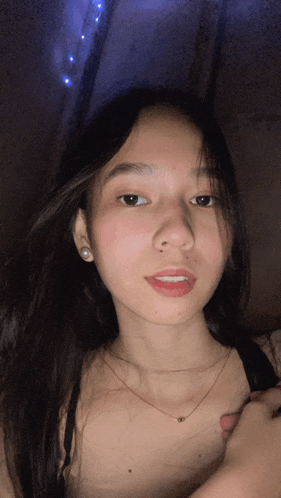 a woman with long hair is wearing a black bra