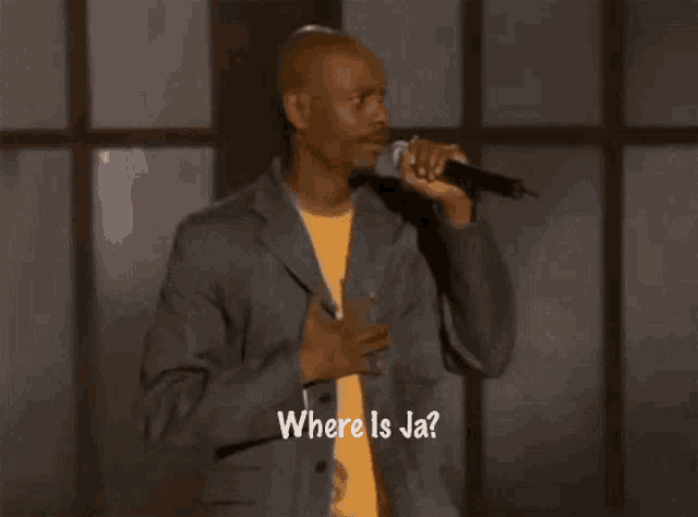 a man singing into a microphone with the words where is ja written on the bottom