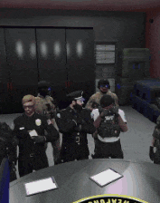 a group of police officers are standing around a table with a weapons sticker on it