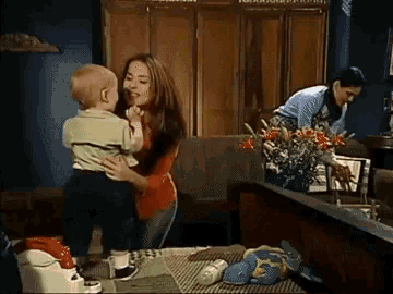 a woman is holding a baby in her arms