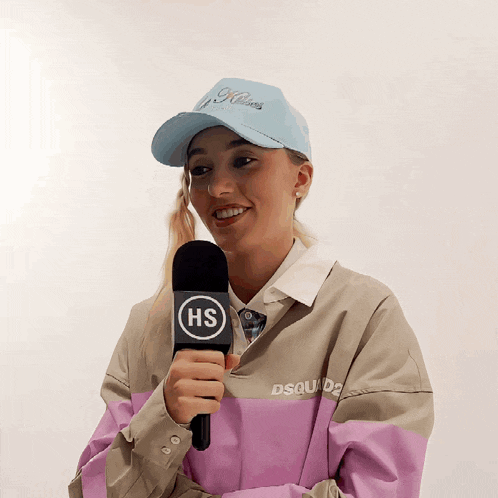 a woman holding a microphone that says hs