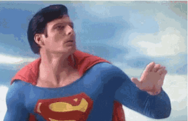 a man in a superman costume is flying through the air