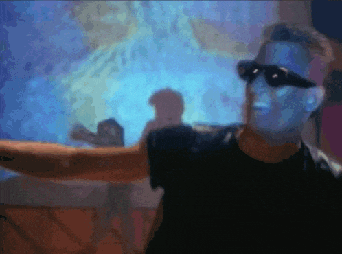 a blurry image of a man wearing sunglasses