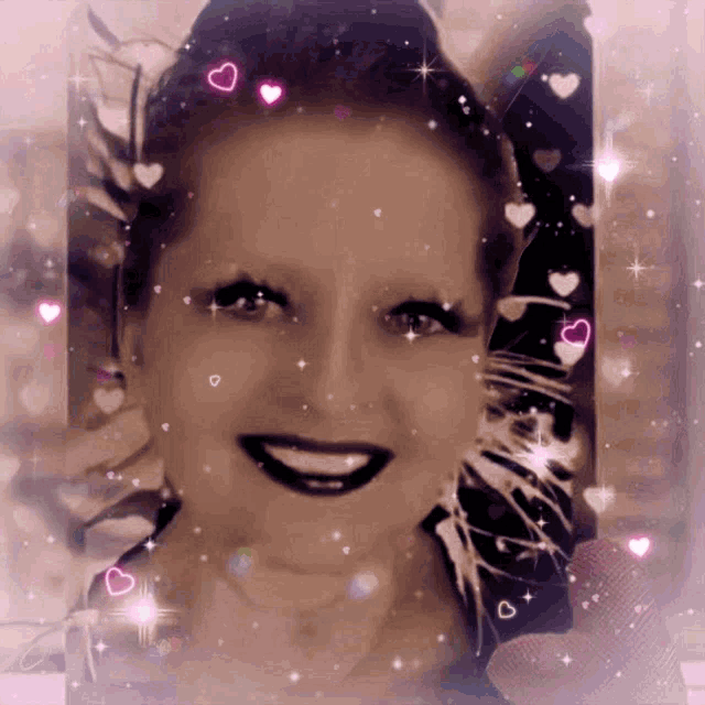 a woman 's face is surrounded by pink hearts and glitter
