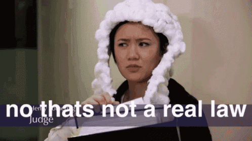 a woman wearing a judge 's hat is holding a book and says no that 's not a real law judge