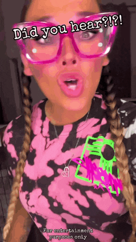 a woman wearing glasses and a tie dye shirt with the words did you hear