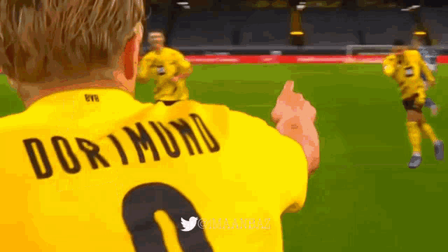 a soccer player wearing a yellow jersey that says dortmund