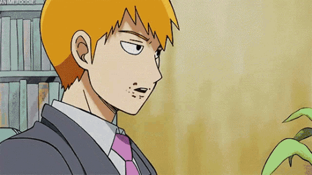 a man with orange hair is wearing a suit and tie