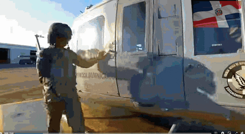 a person is standing in front of a vehicle that says dominican republic