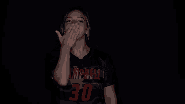 a woman wearing a black shirt with campbell on it
