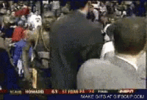 a crowd of people are watching a basketball game with the score 63 to 51