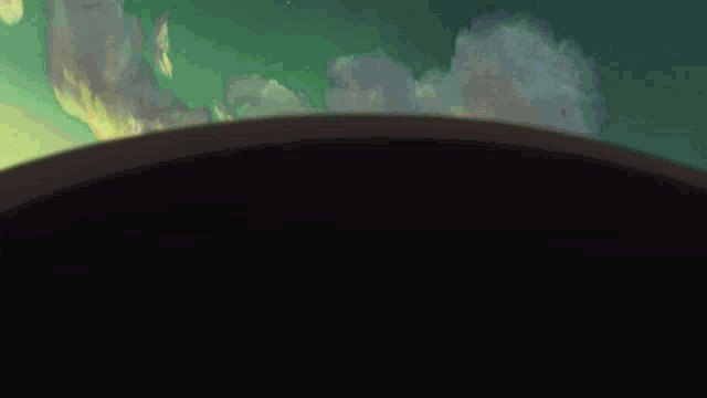 a green background with a black circle in the center