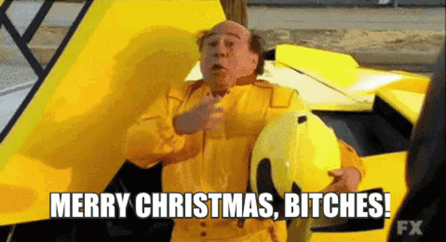 a man in a yellow suit is holding a helmet and says merry christmas bitches