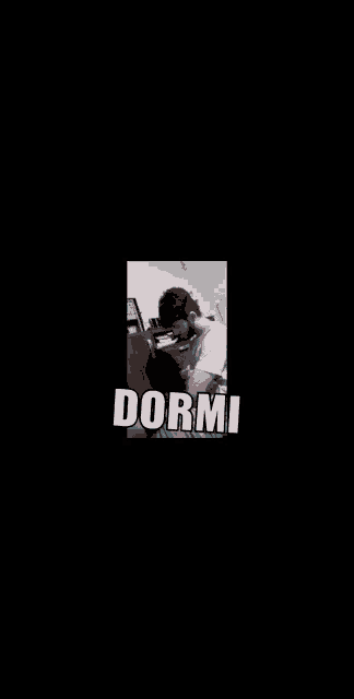 a man is sitting on a couch with his head on a pillow and a sticker that says dormi on it .