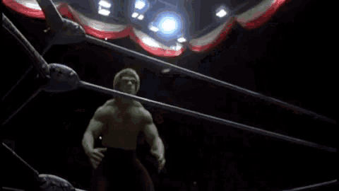 the hulk is flexing his muscles in a gym .