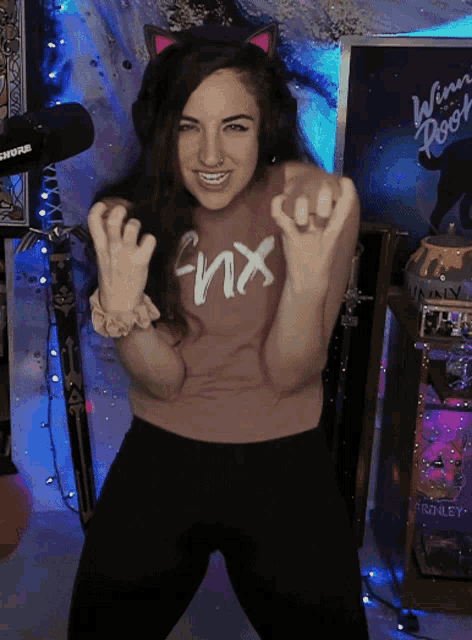 a woman wearing a pink shirt that says fnx
