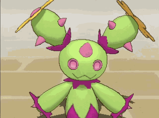 a green and pink cactus with a flower on top