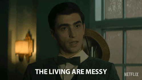 a man in a tuxedo says the living are messy