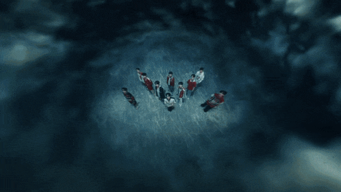 a group of young men are standing in a circle and one of them has the number 12 on their shirt
