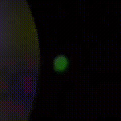 a close up of a green glowing object on a black background