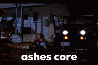 a woman is sitting on the ground in front of a house and the words ashes core are visible