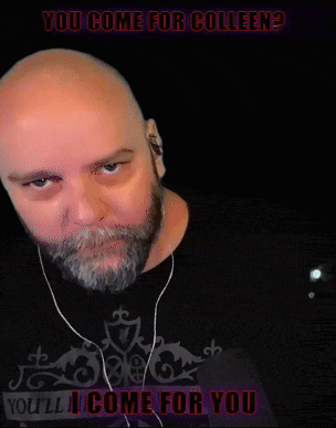 a bald man with a beard wearing ear buds and a shirt that says you come for colleen