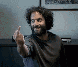 a man with a beard giving the middle finger
