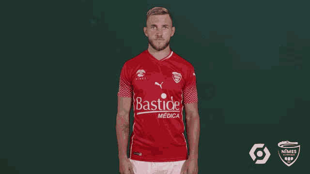a man wearing a red bastide medical shirt