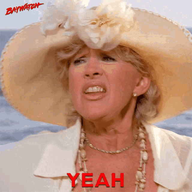 a woman wearing a hat and a white jacket with the word yeah in red