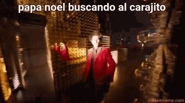 a man in a red jacket is standing in front of a wall with the words papa noel buscando al carajito