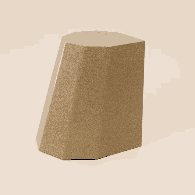 a brown block with a silver stripe on the side sits on a beige surface