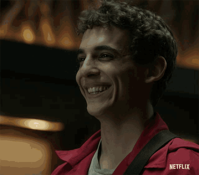a man in a red jacket is smiling with netflix written on the bottom