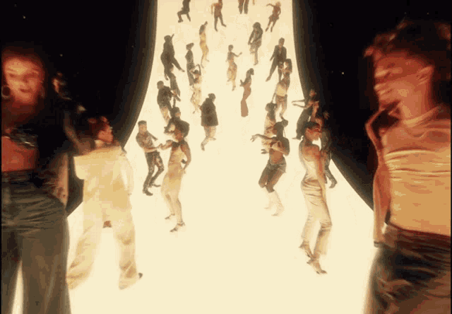a group of people are dancing in a room